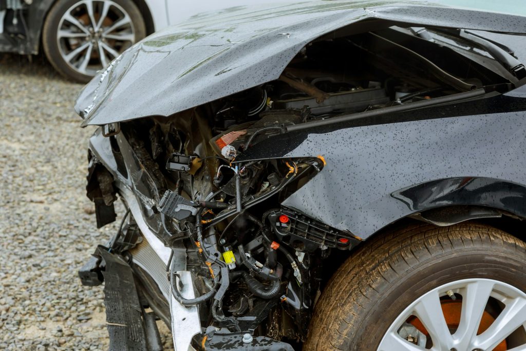 Broken car after accident, view of car front down after an explosion, ready to be scrapped